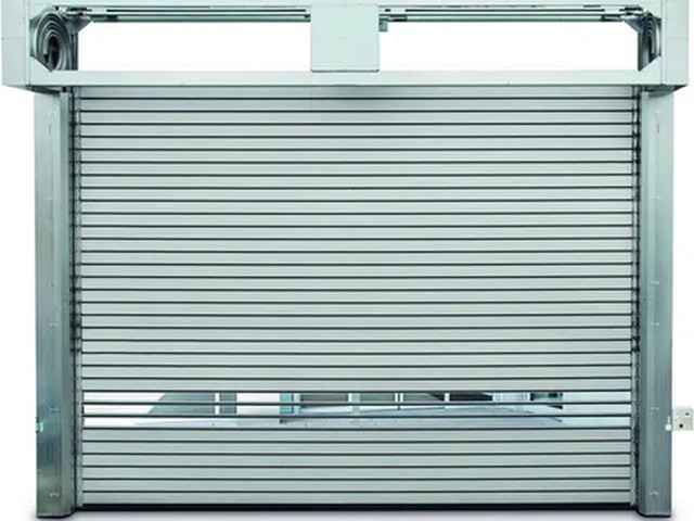 An EFAFLEX high speed spiral door showing the spiral drum and headbox that coils the door leaf above the opening