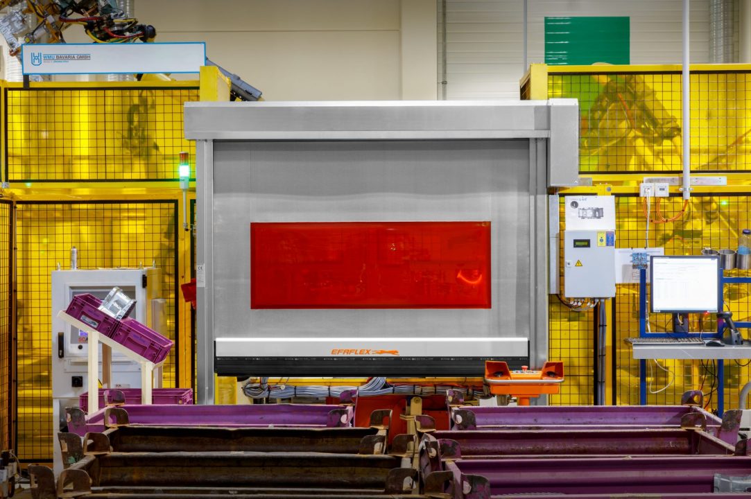 Front close-up of Machine Protection Fabric door with transparent PVC curtain and warning strips